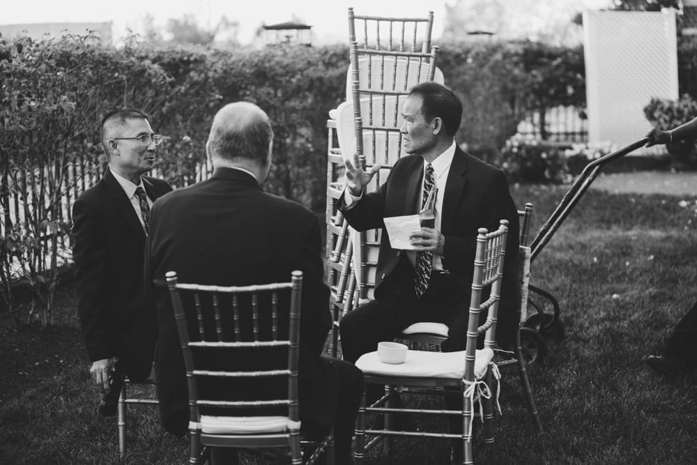 A photojournalistic photograph of wedding guest talking during cocktail hour at the Marriott Hotel Boston