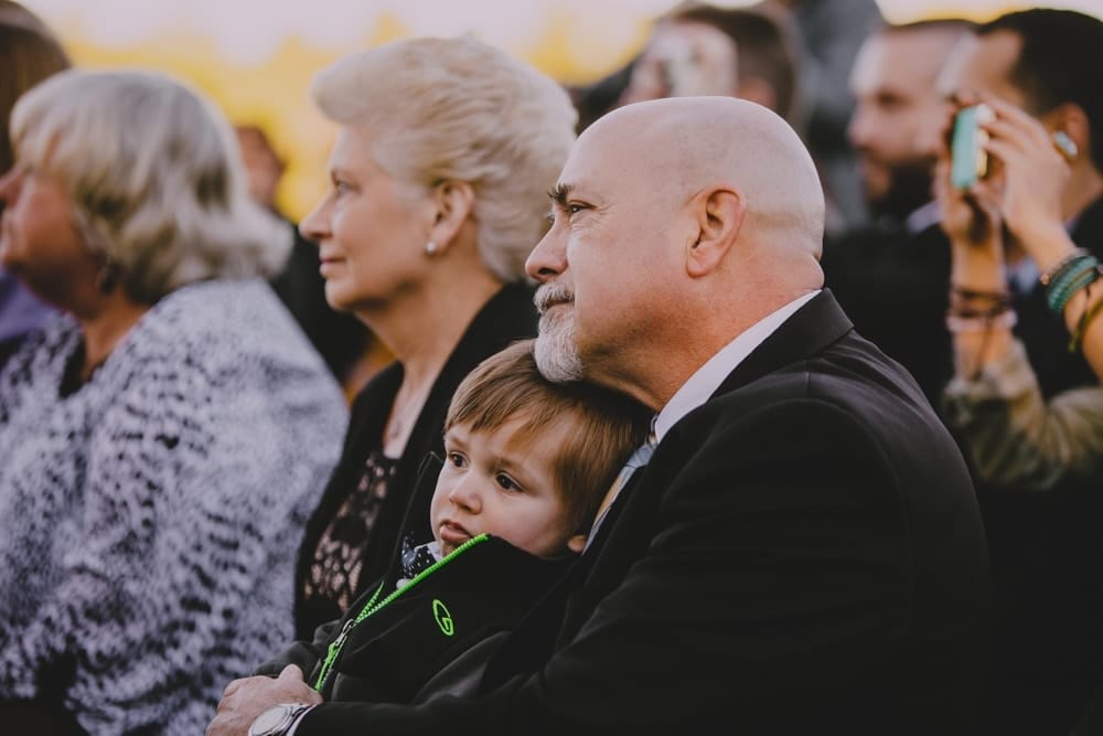 A documentary photograph of wedding guests during an outdoor wedding ceremony at Kitz Farm in New Hampshire