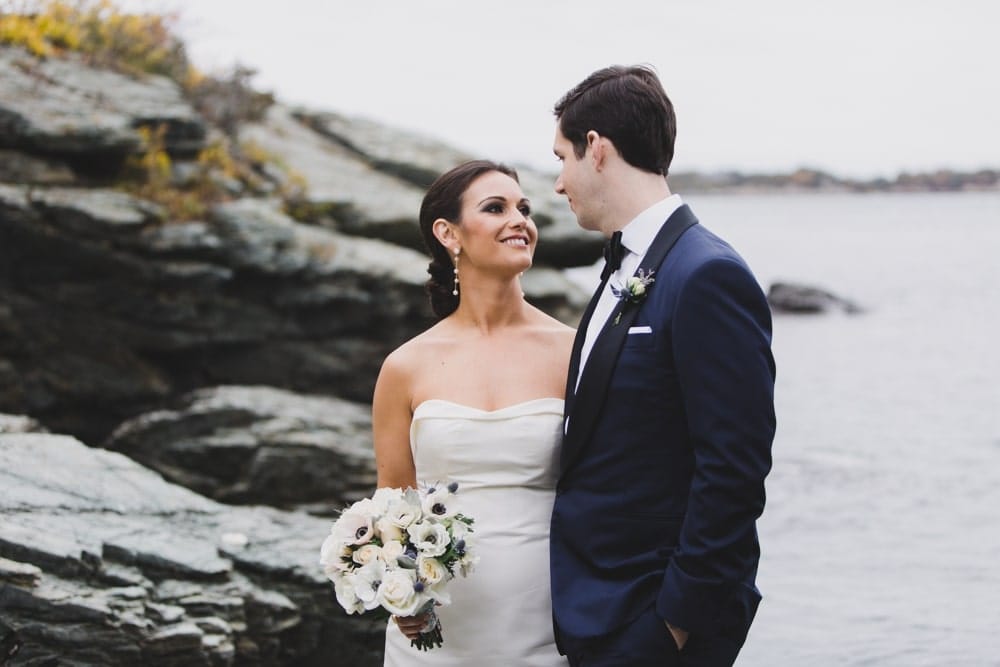 A relaxed portrait of a bride and groom by the ocean during their Castle Hill Inn Wedding in Newport, Rhode Island