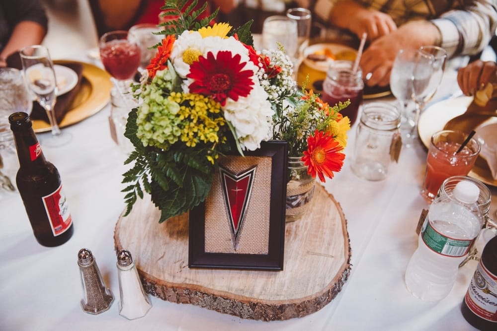 A photojournalistic photograph of DIY rustic motor vehicle inspired wedding decor at a relaxed River Club Wedding in Scituate, Massachusetts