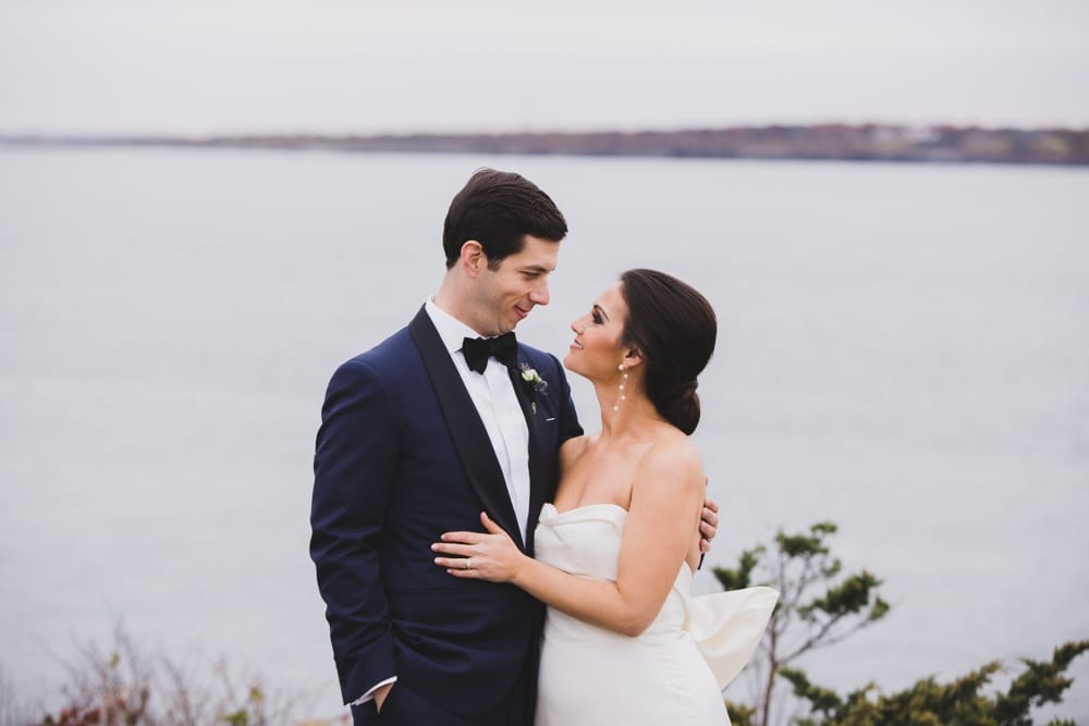A sweet portrait of a bride and groom at the ocean during their Castle Hill Inn Wedding in Newport, Rhode Island
