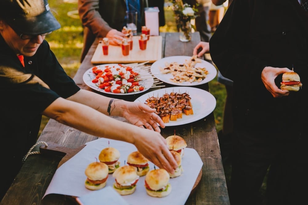 A photojournalistic photograph of rustic and artisan food being served during cocktail hour at a rustic barn wedding at Kitz Farm in New Hampshire