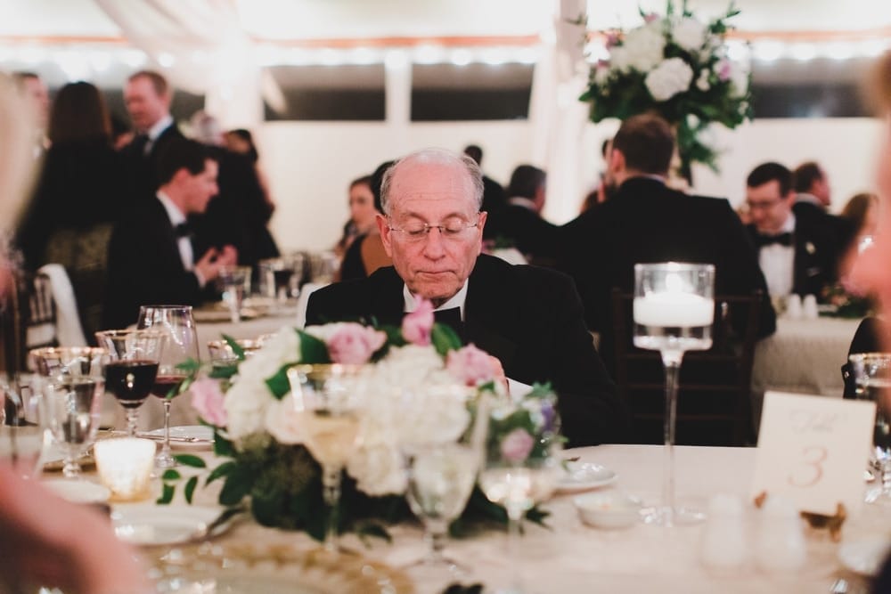 A candid photograph of a wedding guest during a wedding reception at the Castle Hill Inn in Newport, Rhode Island