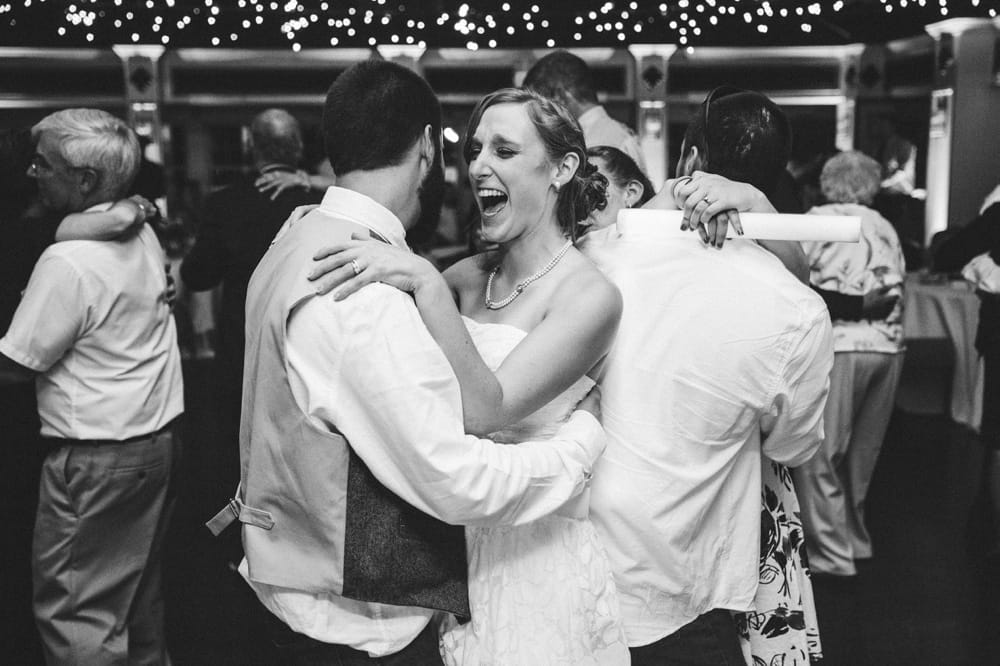 A fun documentary photograph of a bride and groom dancing at their relaxed, rustic River Club Wedding in Scituate, Massachusetts