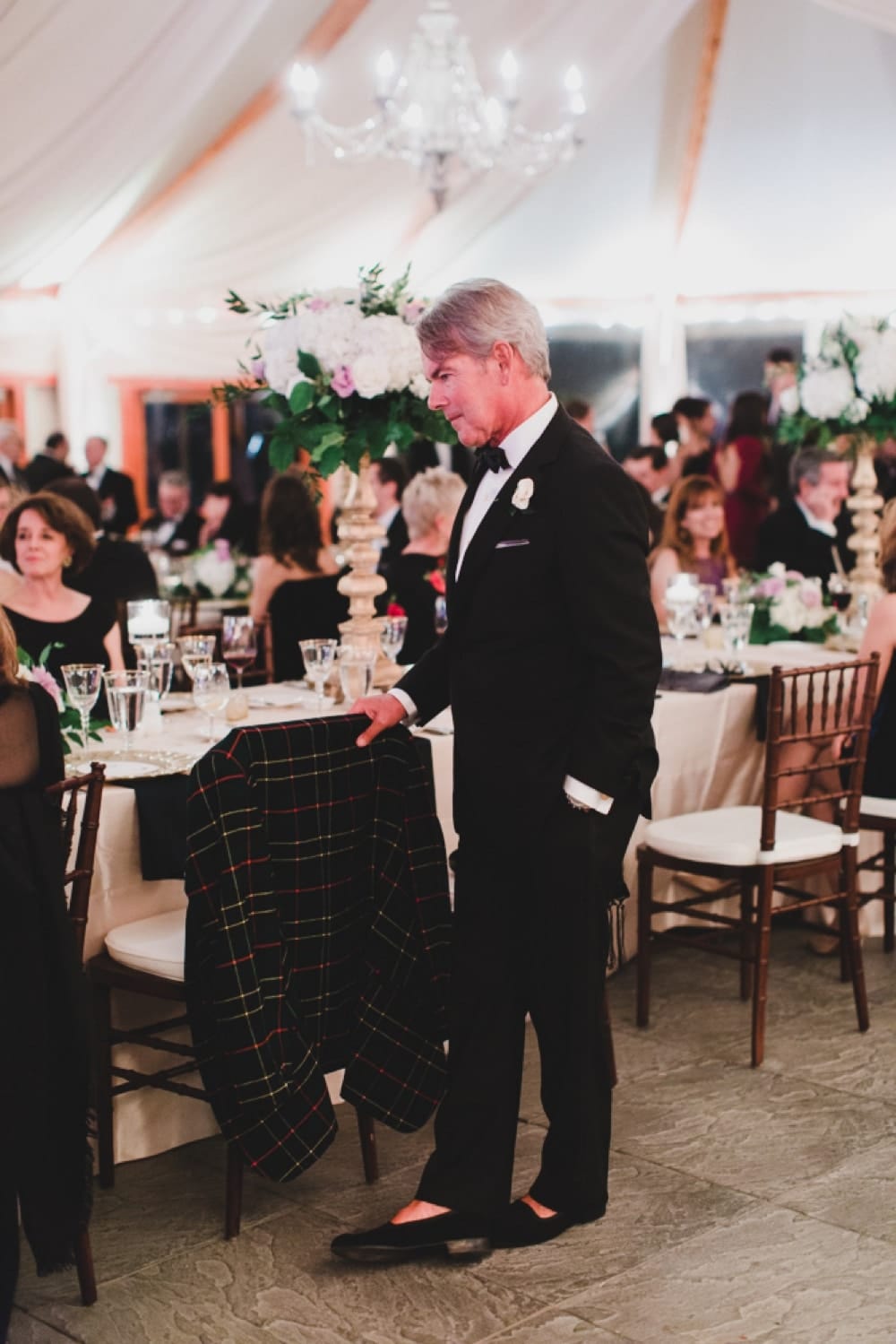 A candid photograph of the father of the groom during a wedding reception at the Castle Hill Inn in Newport, Rhode Island