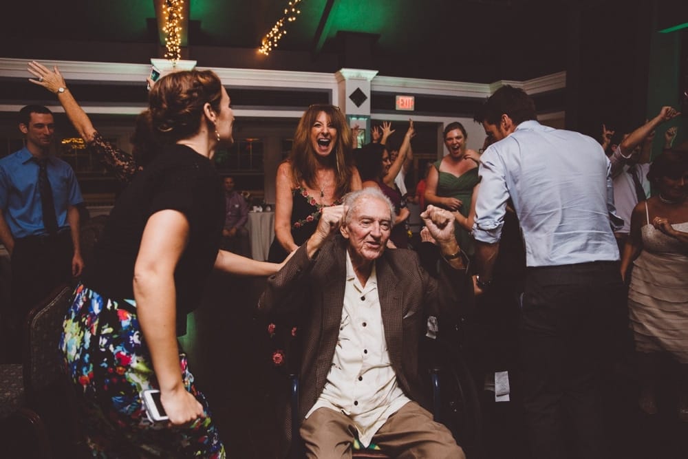 A fun documentary photograph of wedding guest dancing at a relaxed and rustic River Club Wedding in Scituate, Massachusetts