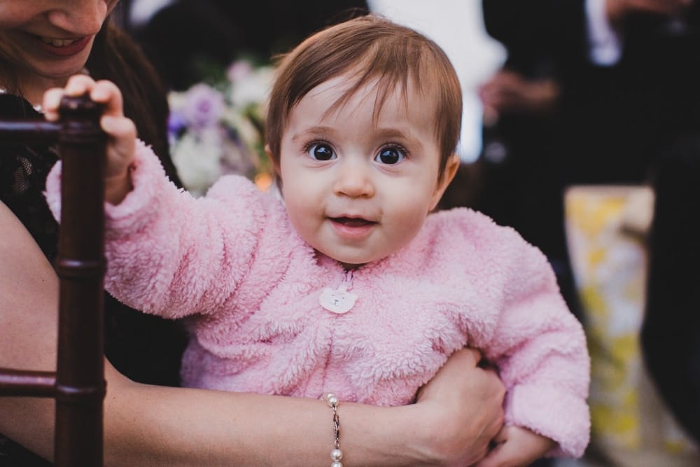 A portrait of a baby smiling at a wedding reception at a Castle Hill Inn Wedding in Newport, Rhode Island