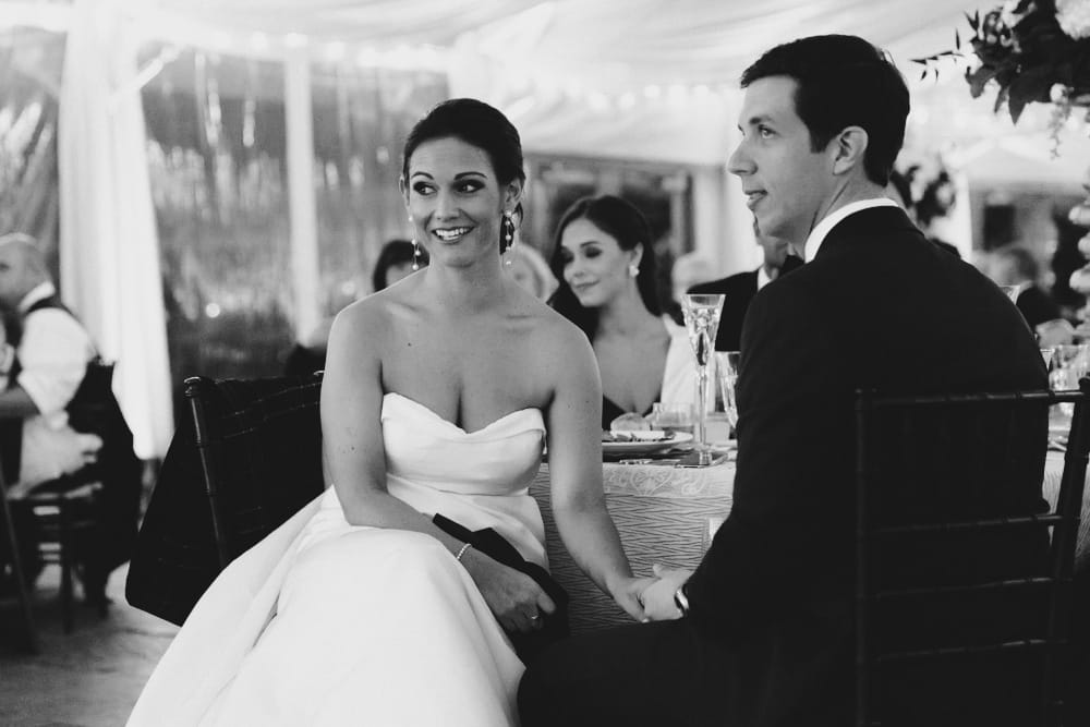 A photojournalistic photograph of a bride and grooms reaction to the best man speech at their Castle Hill Inn Wedding in Newport, Rhode Island