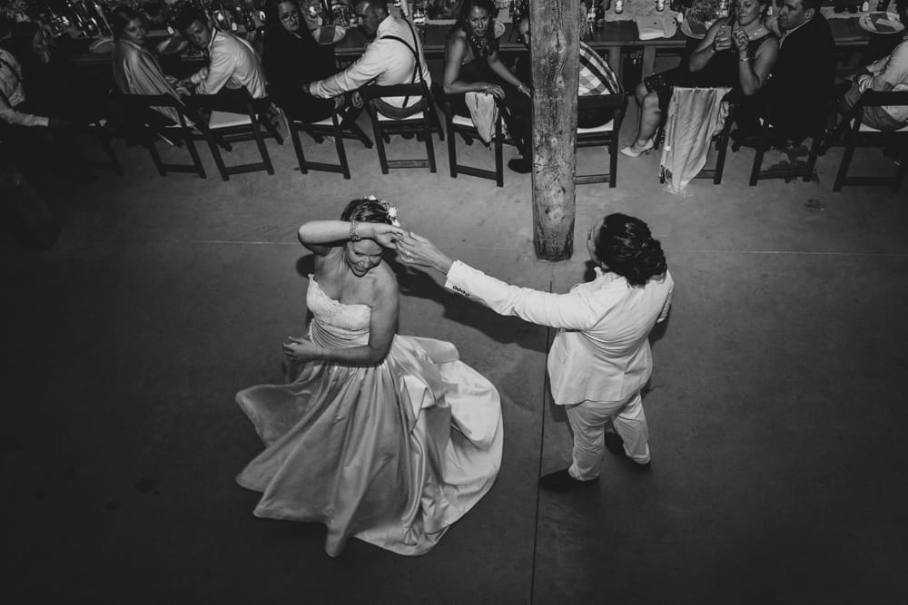 A documentary photograph of a bride and bride having their first dance during their rustic barn wedding at Kitz Farm in New Hampshire