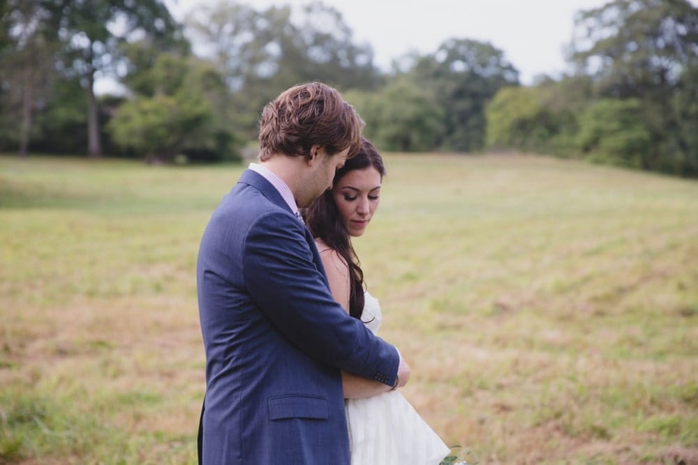 A beautiful and relaxed wedding portrait of a bride and groom at the Minute Man Park before their backyard wedding in Massachusetts