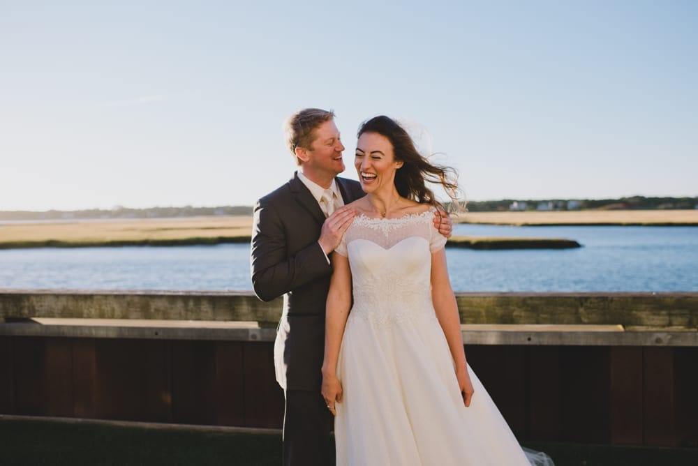 A relaxed, fun and candid wedding portrait of a bride and groom during their outdoor wedding on Cape Cod