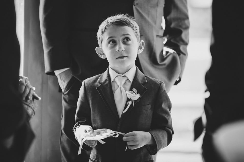 A photojournalist photograph of a ring bearer moments before a wedding ceremony in Cape Cod, Massachusetts
