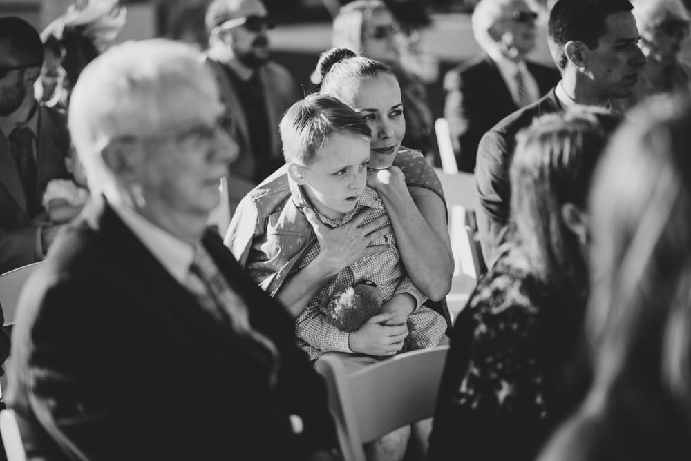 A photojournalist photograph of guest watching an outdoor Jewish wedding ceremony in Cape Cod, Massachusetts