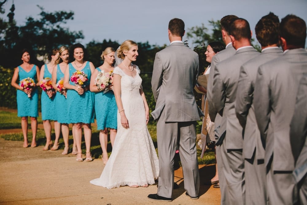 A documentary photograph of a couple saying their vows during an outdoor wedding ceremony at Cape Cod's Pilgrim's Monument in Provincetown, Massachusetts