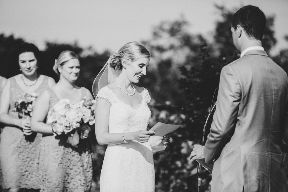A documentary photograph of bride reading her vows during her Cape Cod Wedding Ceremony at the Pilgrim's Monument in Provincetown, Massachusetts