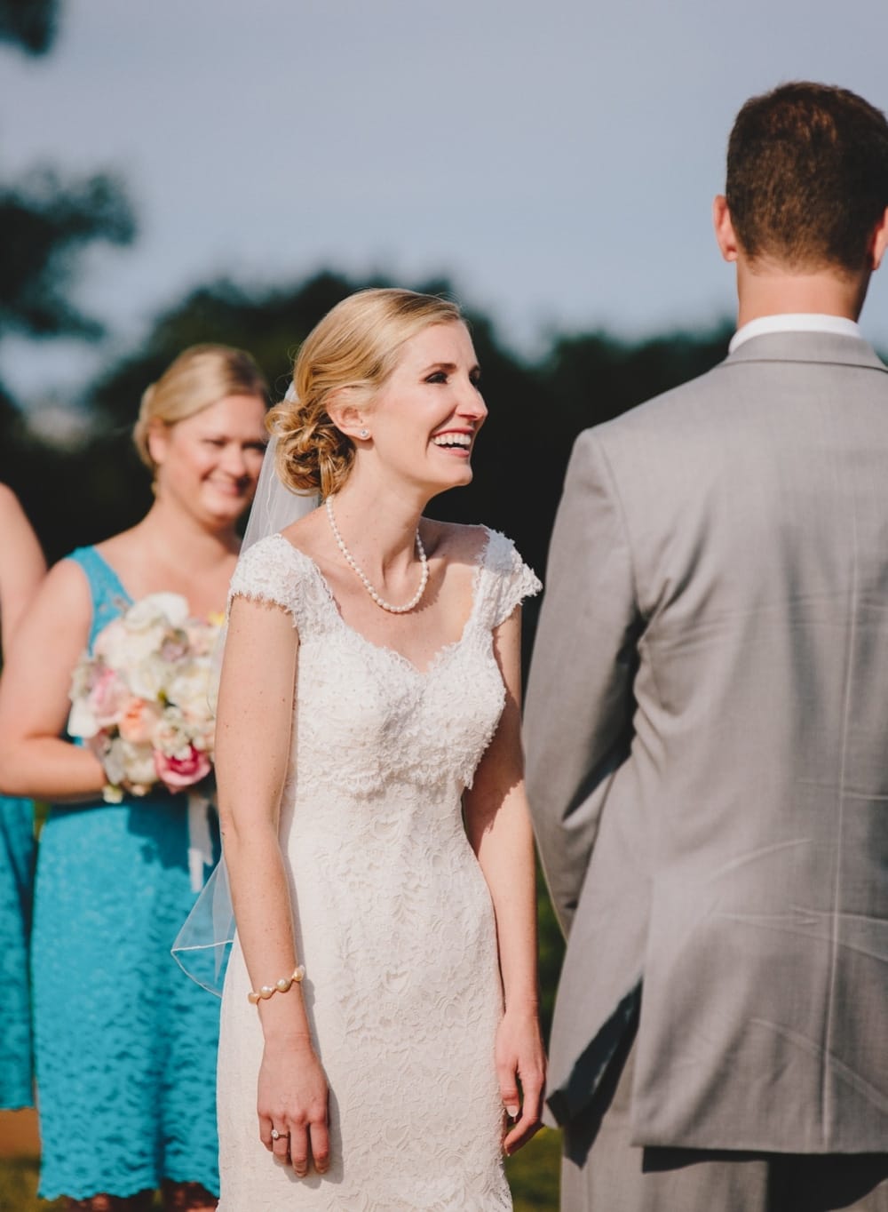 A documentary photograph of a bride laughing during her Cape Cod wedding ceremony at Pilgrim's Monument in Provincetown, Massachusetts