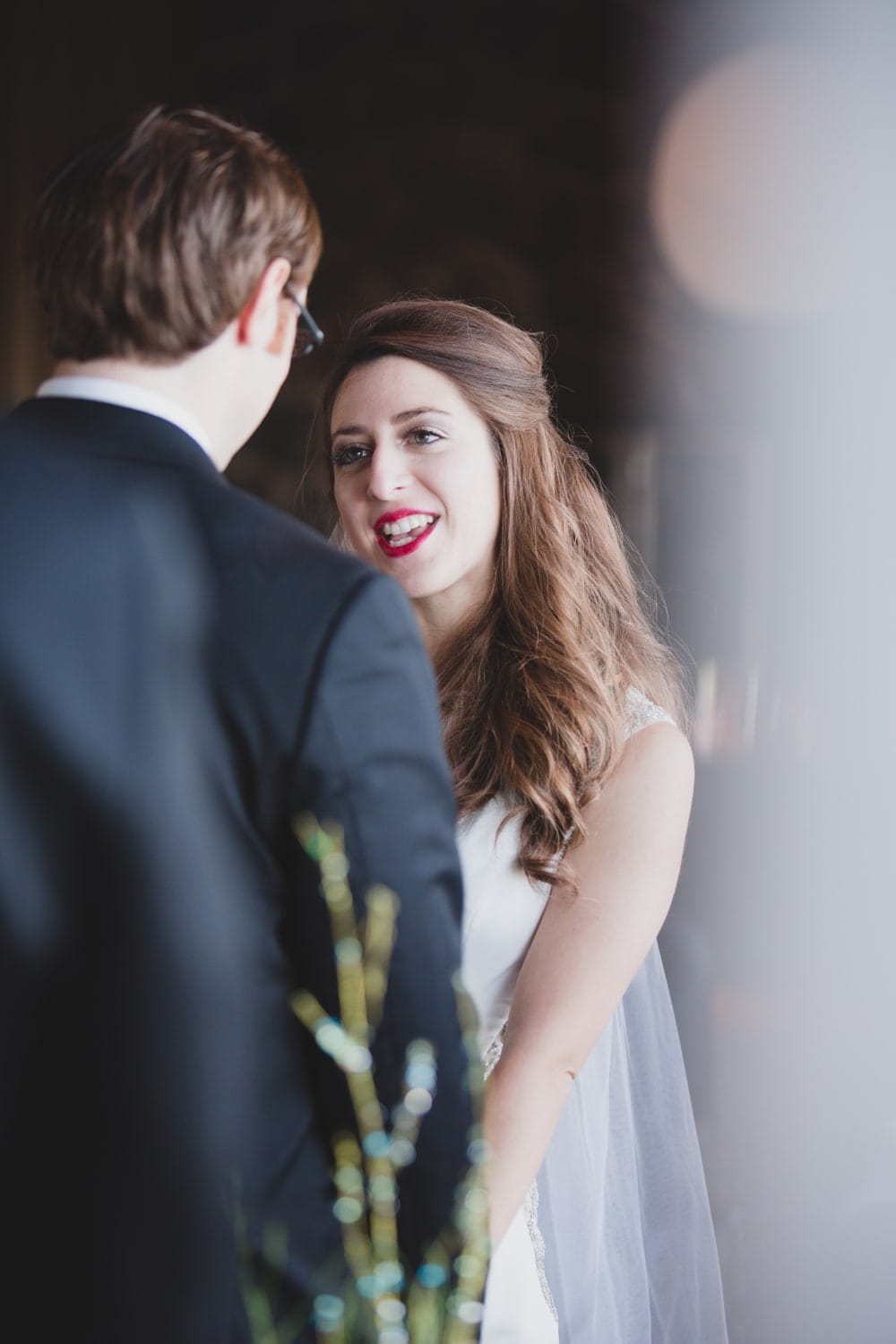 A photojournalistic photograph of a bride saying her wedding vows during an intimate wedding at the Oceanview of Nahant in Massachusetts