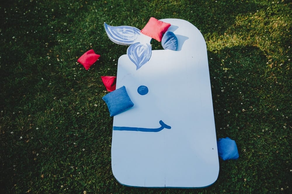 A detailed photograph of lawn games during a fun summertime wedding at Cape Cod's Pilgrim Monument in Provincetown, Massachusetts