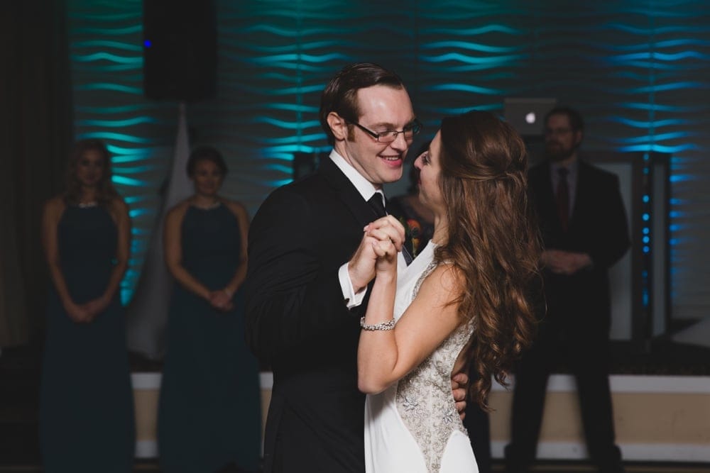 A photojournalistic photograph of a bride and groom sharing their first dance as husband and wife during an intimate Massachusetts Wedding the Oceanview of Nahant