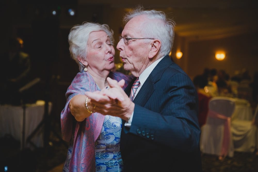 A photojournalistic photograph of a couple dancing during a summer time wedding in Cape Cod