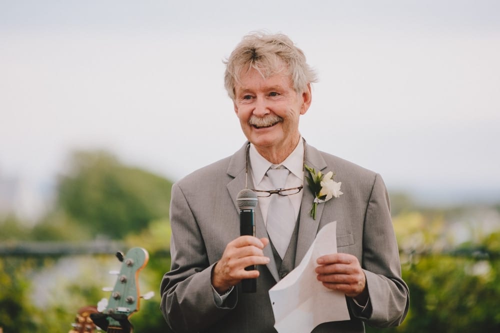 A father of the bride gives a speech during a fun, summertime Cape Cod wedding at the Pilgrim's Monument in Provincetown, Massachusetts