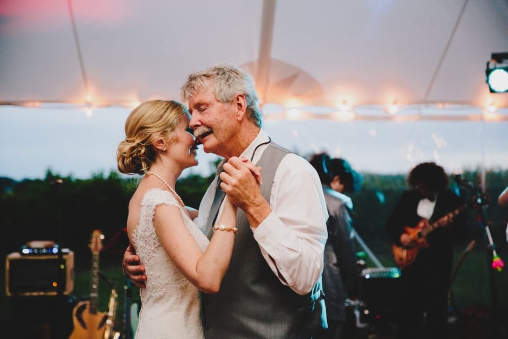 A documentary photograph of a father daughter dance during a fun, summertime Cape Cod wedding at Pilgrim's Monument in Provincetown, Massachusetts