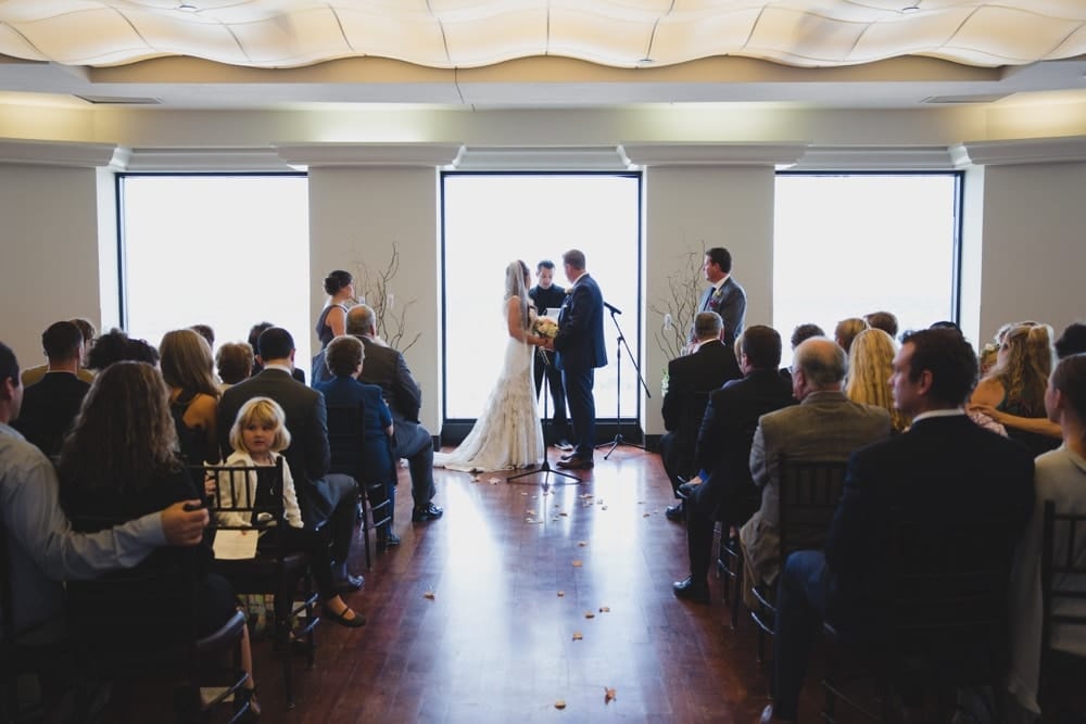 A documentary photograph of a bride and groom saying their vows during the ceremony at their State Room Wedding in Boston