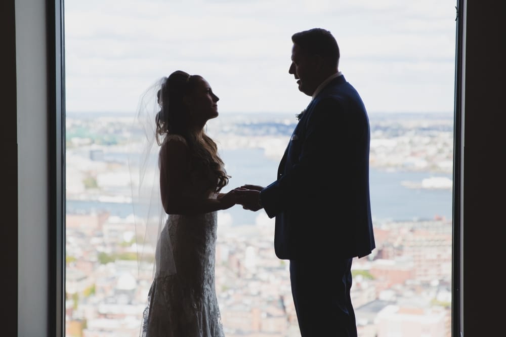 A documentary photograph of a bride and groom saying their vows during their State Room Wedding in Boston