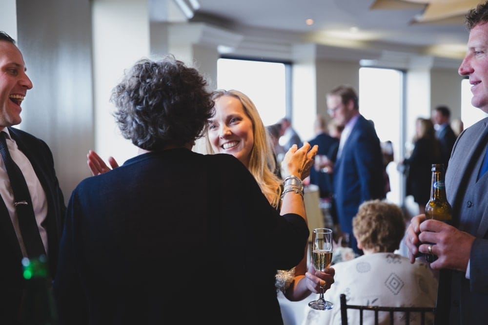 A documentary photograph of guest hugging at a State Room Wedding in Boston