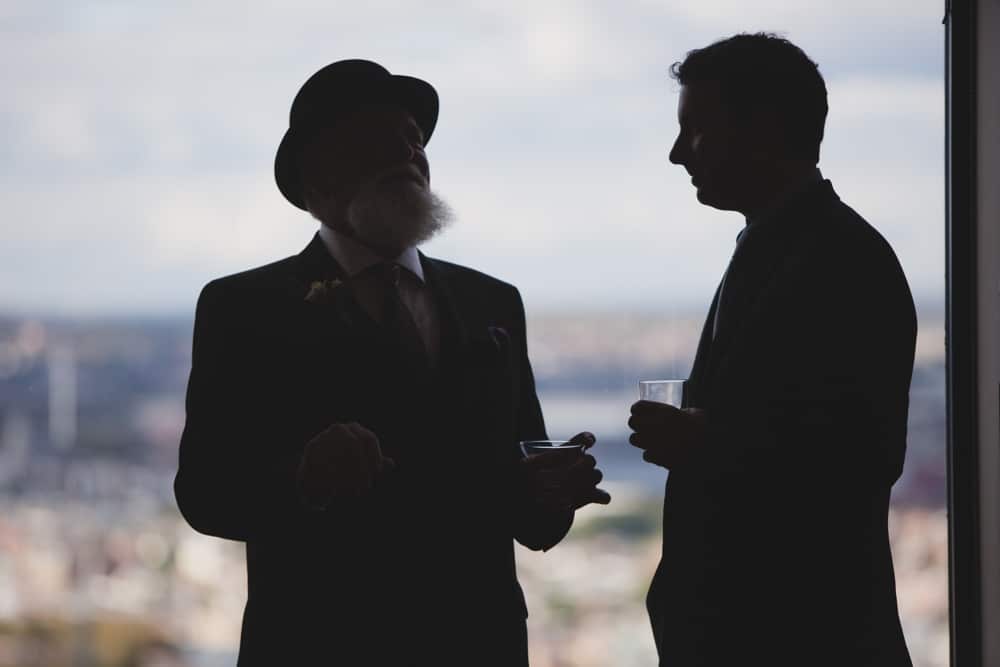 A photojournalistic photograph of guests talking during a State Room Wedding in Boston