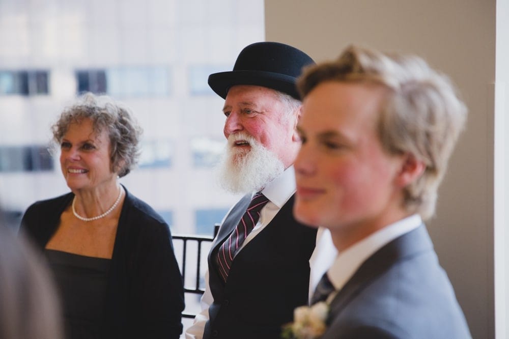 A documentary photograph of a family smiling during the toasts at a State Room Wedding in Boston