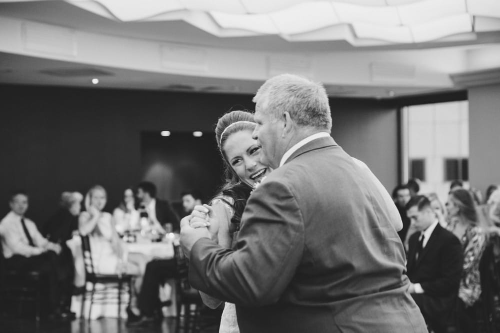 A documentary photograph of a bride dancing with her father during her State Room Wedding in Boston