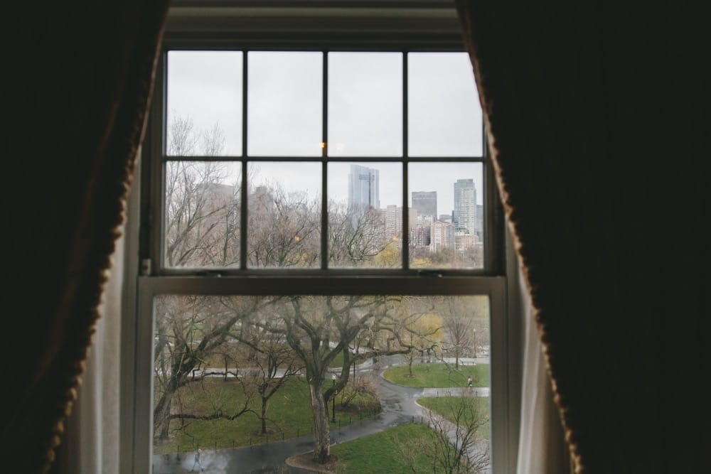 A documentary photograph showing the view of the Boston Public Gardens from the Groom's hotel room in the Taj Boston Hotel during a classic wedding