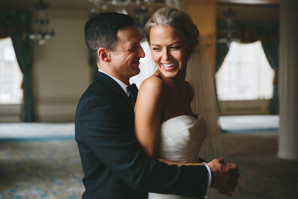 A natural portrait of a bride and groom laughing during their first look at a Taj Boston Hotel Wedding in Massachusetts