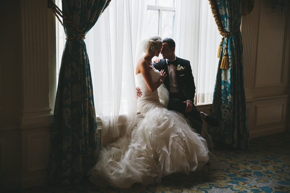 A documentary photograph of a bride and groom sitting together after their first look before their Taj Boston Hotel Wedding in Massachusetts