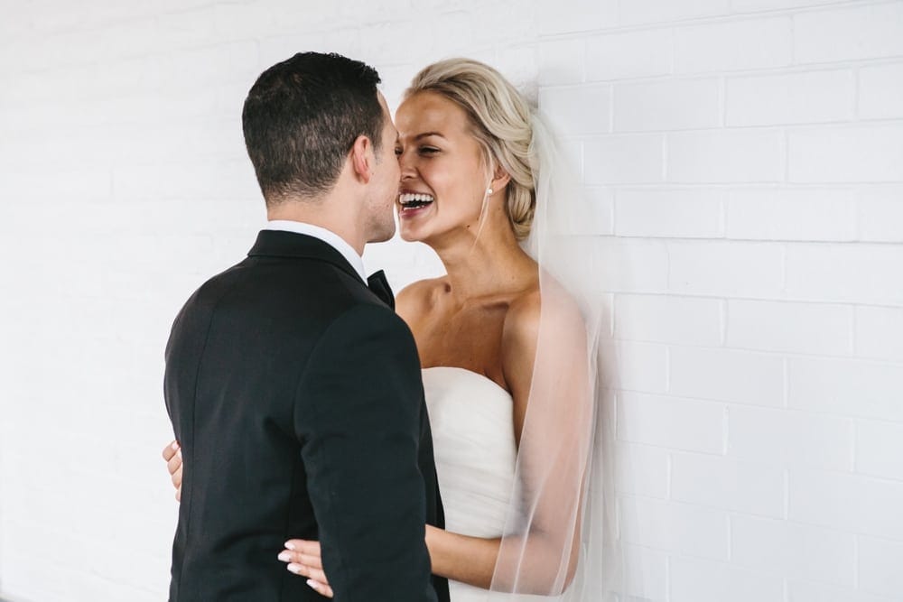 A documentary photograph of a bride laughing with her groom before their Taj Boston Hotel Wedding