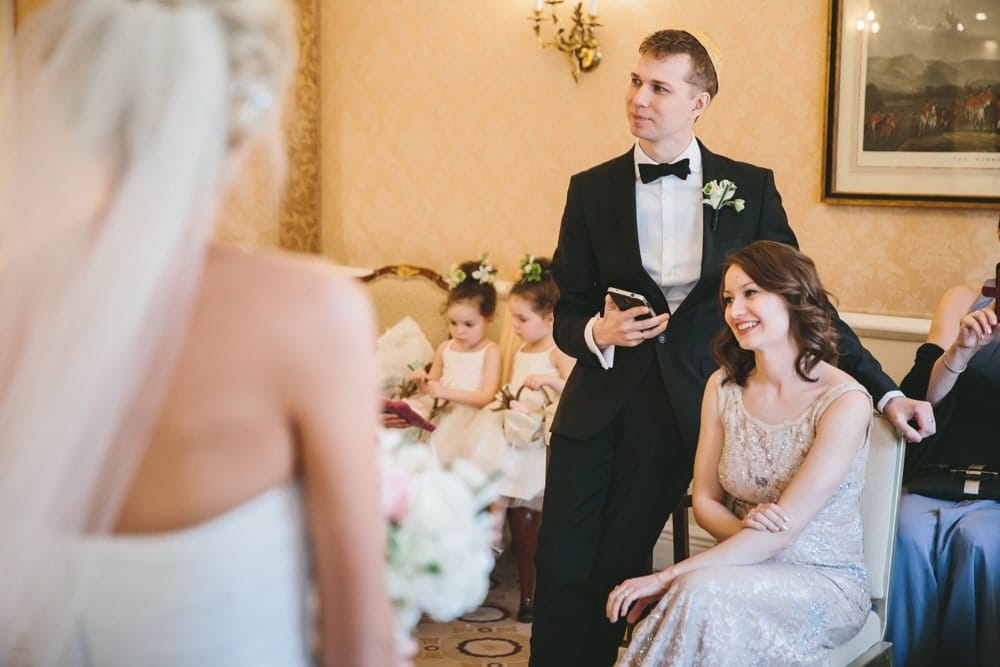 A documentary photograph of the wedding party talking and laughing during a Taj Boston Hotel Wedding in Massachusetts