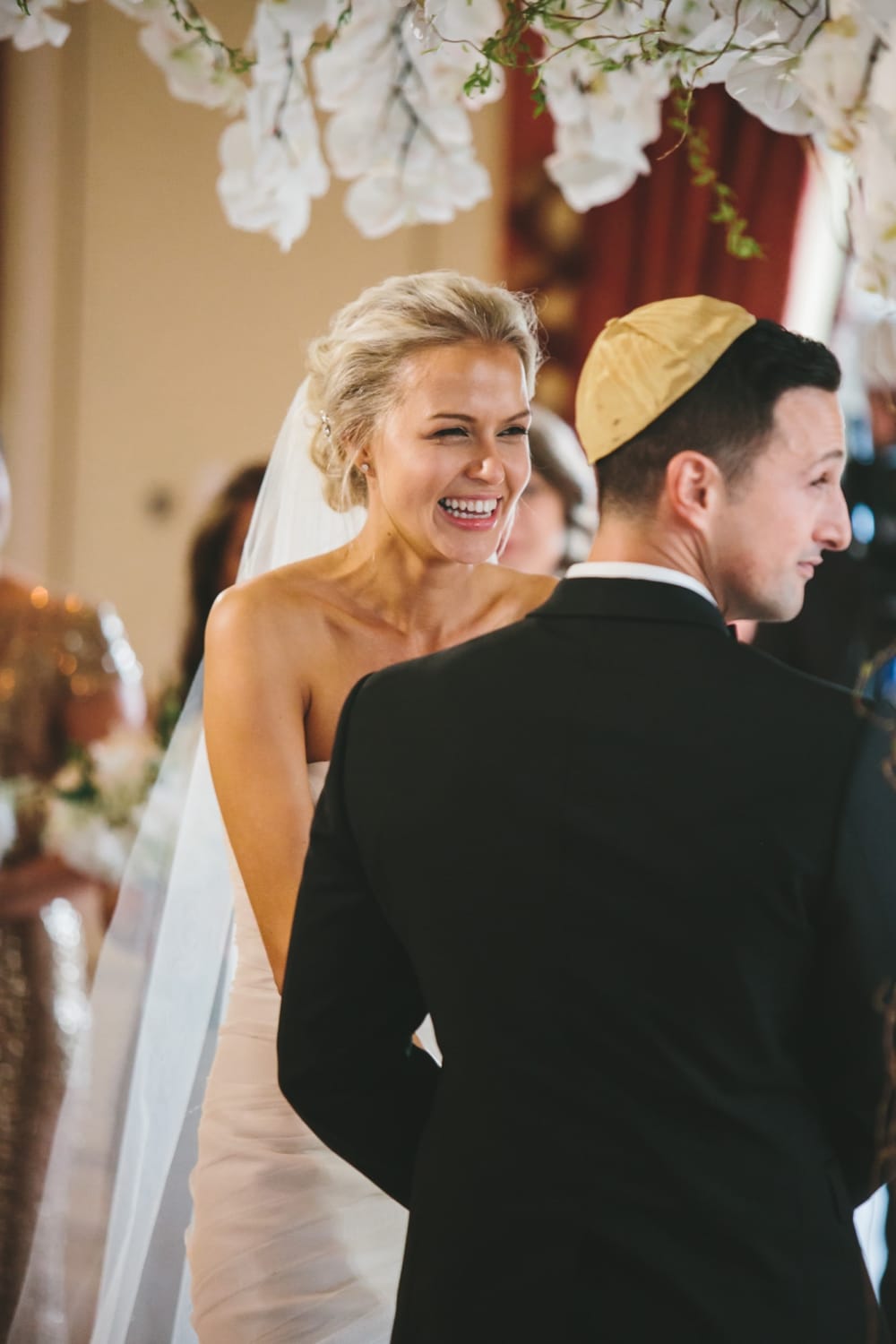 A documentary photograph of a bride laughing during the ceremony of their Taj Boston Hotel Wedding in Massachusetts