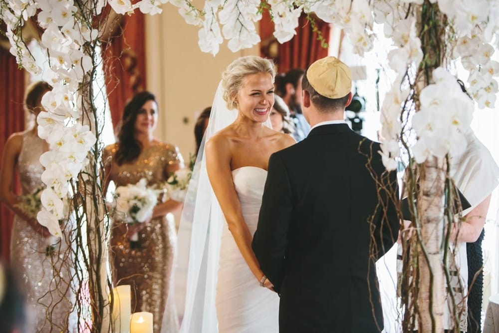 A documentary photograph of a bride smiling during their ceremony at a Taj Boston Hotel Wedding in Massachusetts