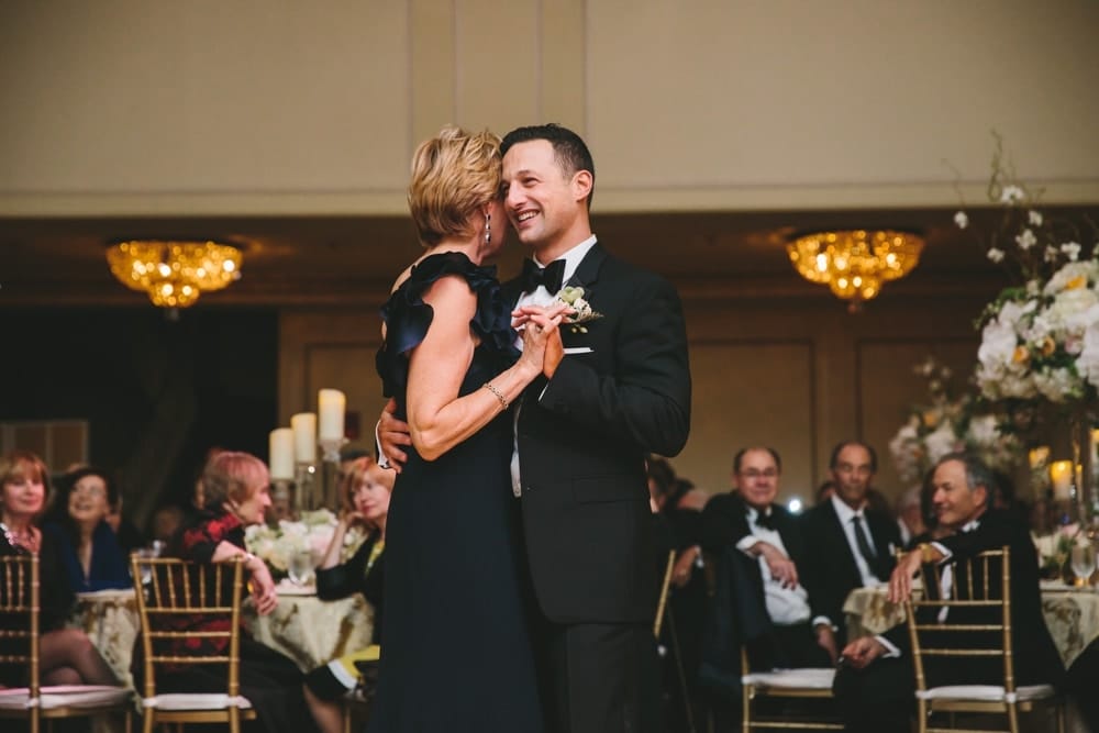 A documentary photograph of a groom dancing with his mother during a mother son dance at their Taj Boston Hotel Wedding in Massachusetts