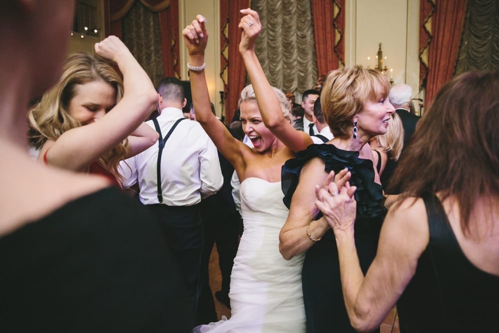 A documentary photograph of a bride dancing with guests during a Taj Boston Hotel Wedding in Massachusetts