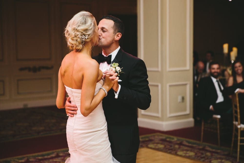 A documentary photograph of a bride and groom kissing on the dance floor during their Taj Boston Hotel Wedding in Massachusetts