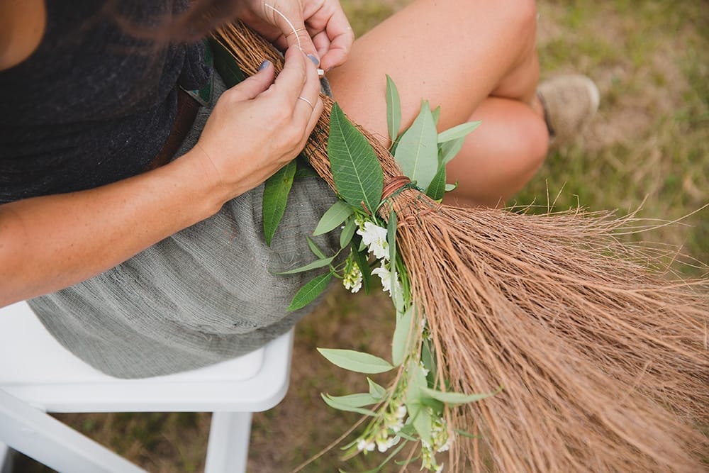 A documentary photograph of a woman creating the floral arrangements before a wedding on Martha's Vineyard