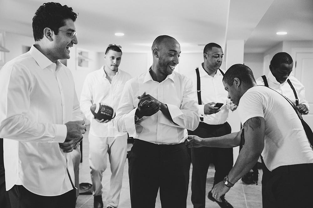 A documentary photograph of Groomsmen getting ready before a Martha's Vineyard Wedding