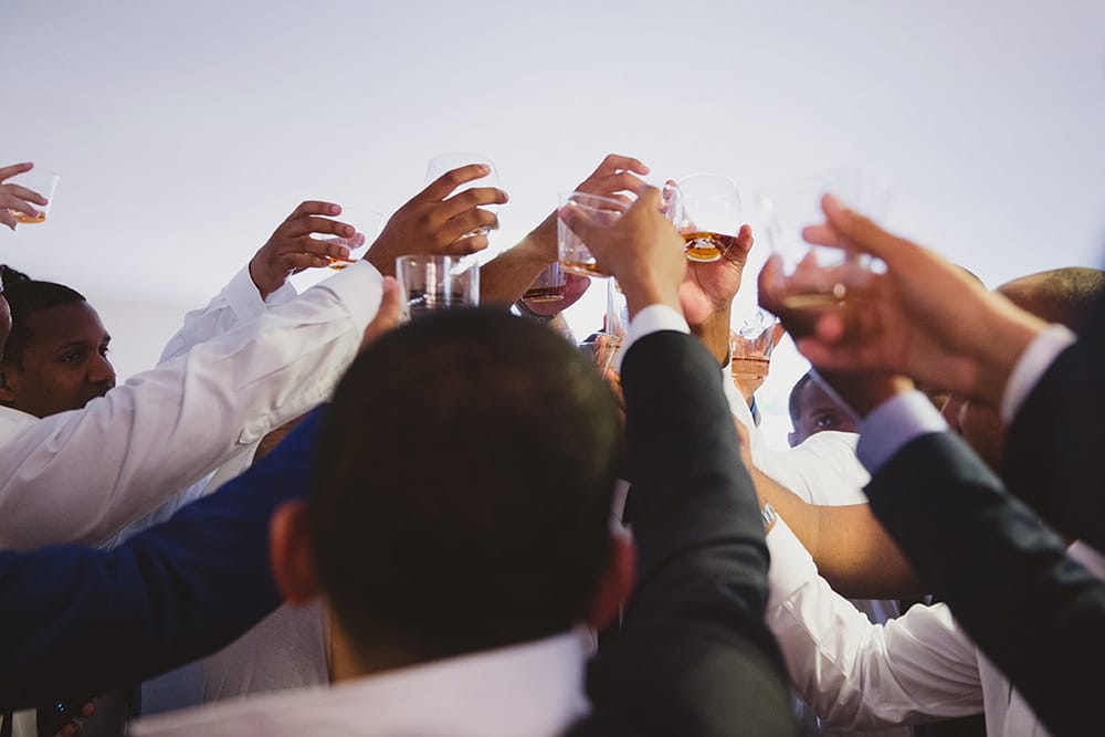 A documentary photograph of Groomsmen having a toast before a Martha's Vineyard Wedding