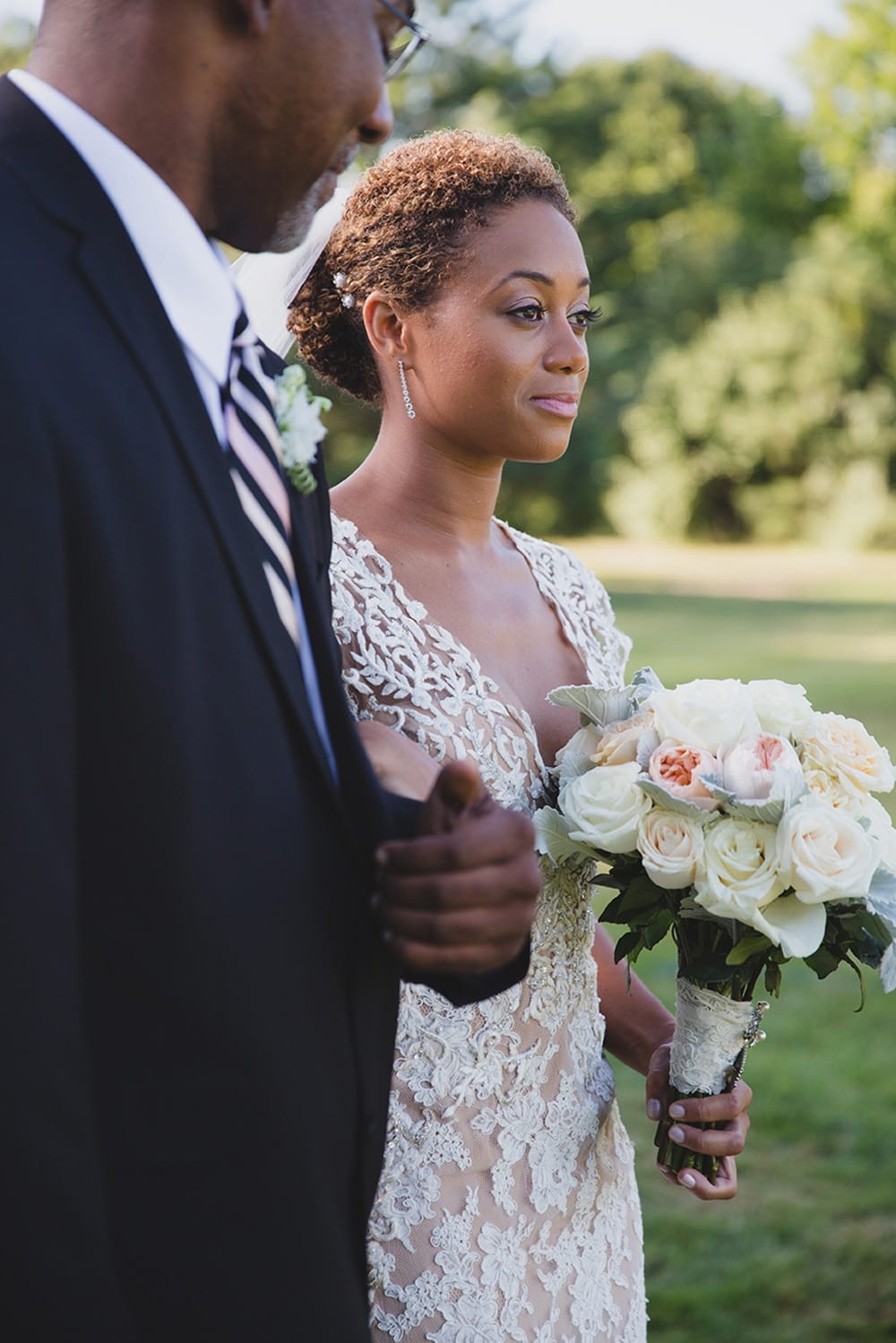 A documentary photograph of a bride walking down the aisle with her father during her Martha's Vineyard Wedding