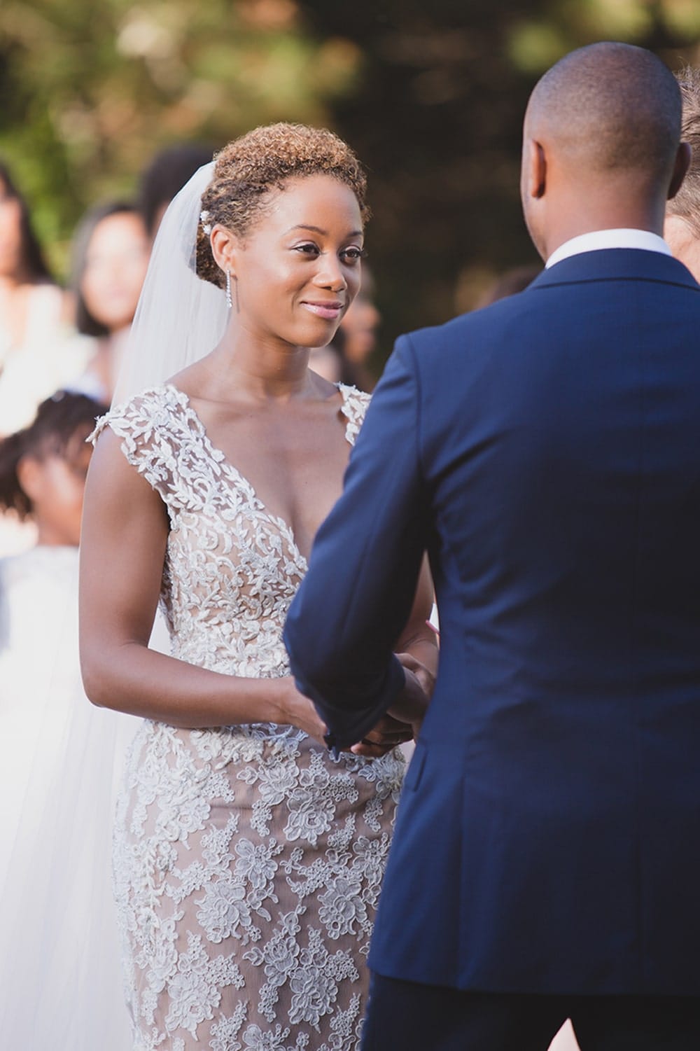 A documentary photograph of bride looking at her groom during their wedding ceremony on Martha's Vineyard