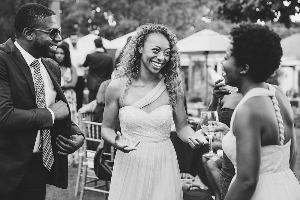 A documentary photograph of bridesmaids laughing and talking during cocktail hour at a Martha's Vineyard Wedding