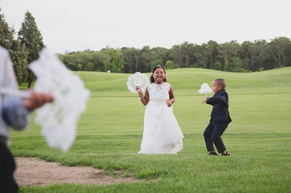 A documentary photograph of kids playing on farm neck golf course during a Martha's Vineyard Wedding