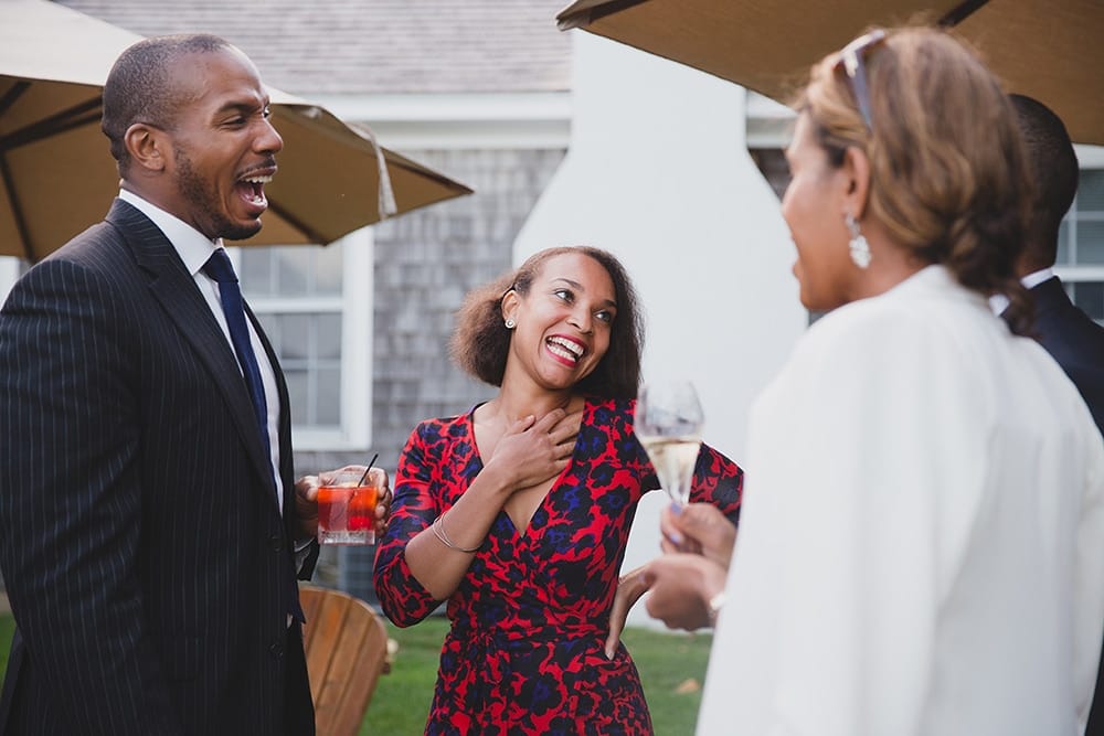 A documentary photograph of guests talking and laughing during the cocktail hour of Martha's Vineyard Wedding